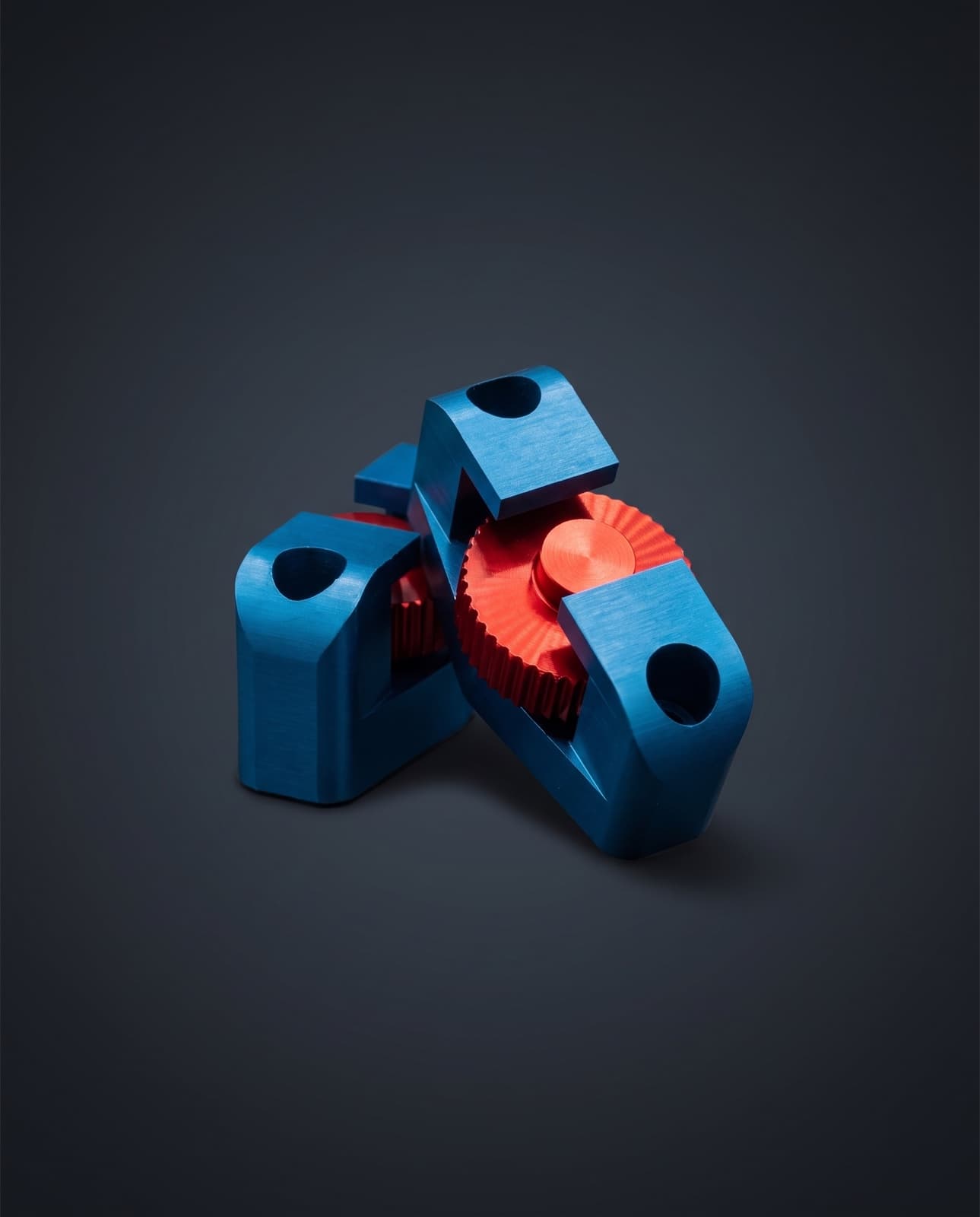 Late-model WP fork adjusters — blue anodised bodies assembled with the red knurled adjuster knob
