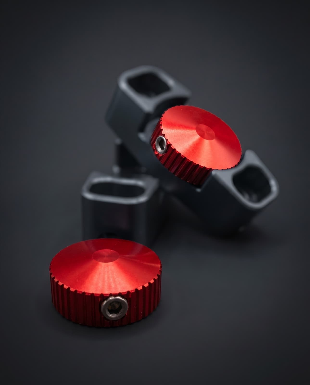 Red anodised knurled WP fork adjuster knobs, shown with adjuster bodies greyed out because only the red knobs are included